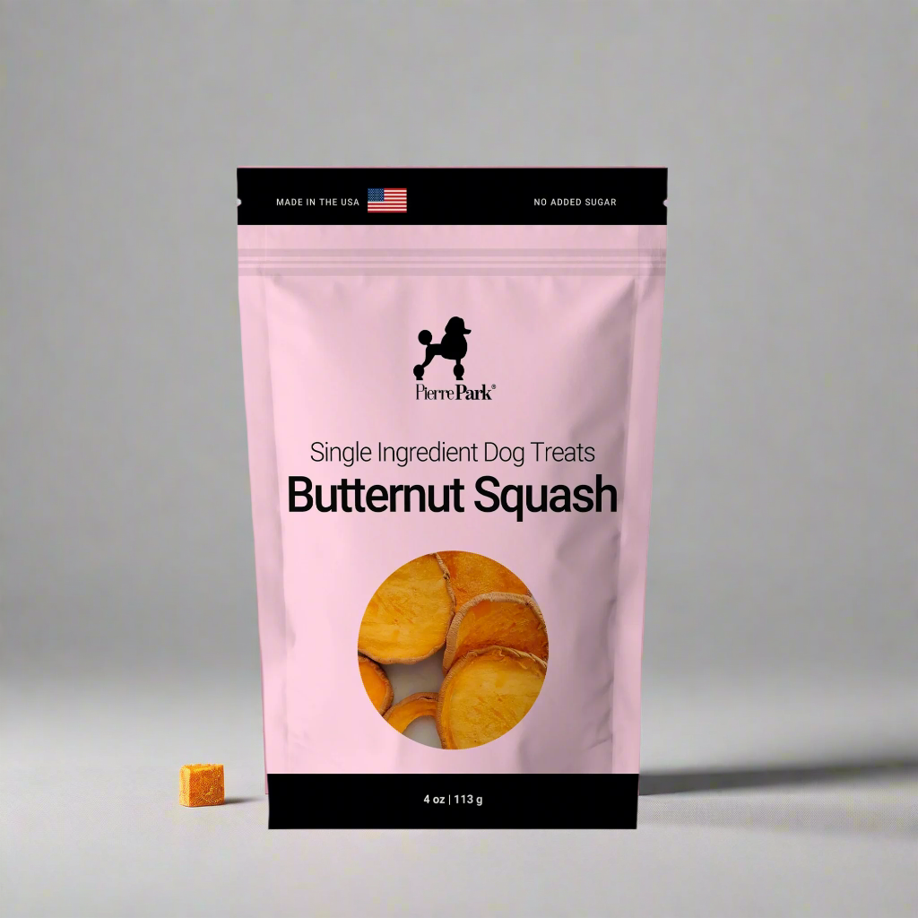 PierrePark butternut squash dog treats in a pink bag, marked Made in the USA and No Added Sugar. The package features a clear window displaying neatly sliced butternut squash, highlighting the treats as a single-ingredient, healthy option for dogs, with a small piece of the treat visible to the left of the bag.