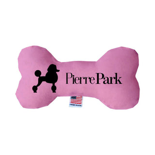 A bright pink bone-shaped toy by PierrePark features a poodle silhouette and brand text. It includes an American flag tag at the bottom.