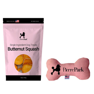 The PierrePark Butternut Squash Dog Treats & Dog Toy Bundle includes a pink bag of single-ingredient treats showcasing the treat image, and a pink bone-shaped toy with the PierrePark logo and an American flag tag.