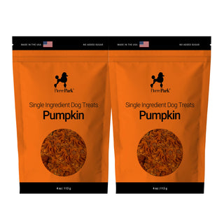 Two orange bags of PierrePark Pumpkin Dog Treats, each 4 oz (113 g), featuring a dog silhouette and an American flag on the packaging to show they're made in the USA.