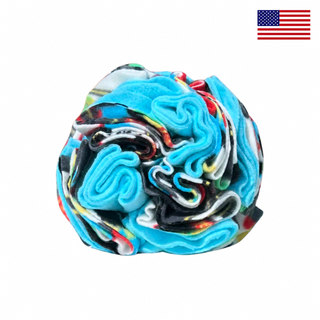 Blue Games snuffle ball for dogs on a white background with a small American flag in the upper-right corner.