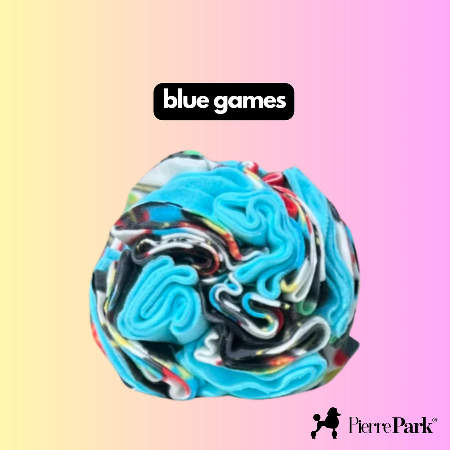 Snuffle ball for dogs by PierrePark labeled 'blue games,' featuring vibrant blue and turquoise swirls on a soft pastel pink and yellow gradient background. This toy is designed to engage dogs in sniffing and foraging activities, enhancing their sensory skills.