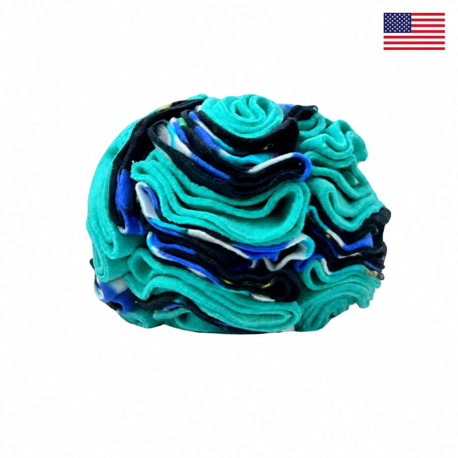 Turquoise Fireflies snuffle ball for dogs on a white background with a small American flag in the upper-right corner.