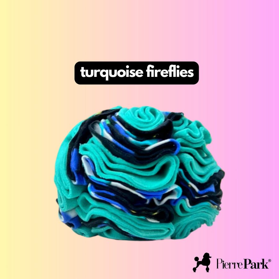 Snuffle ball for dogs by PierrePark named 'turquoise fireflies,' featuring rich swirls of turquoise and deep blue on a pastel pink and yellow background. This colorful toy promotes mental enrichment and sensory stimulation for dogs.